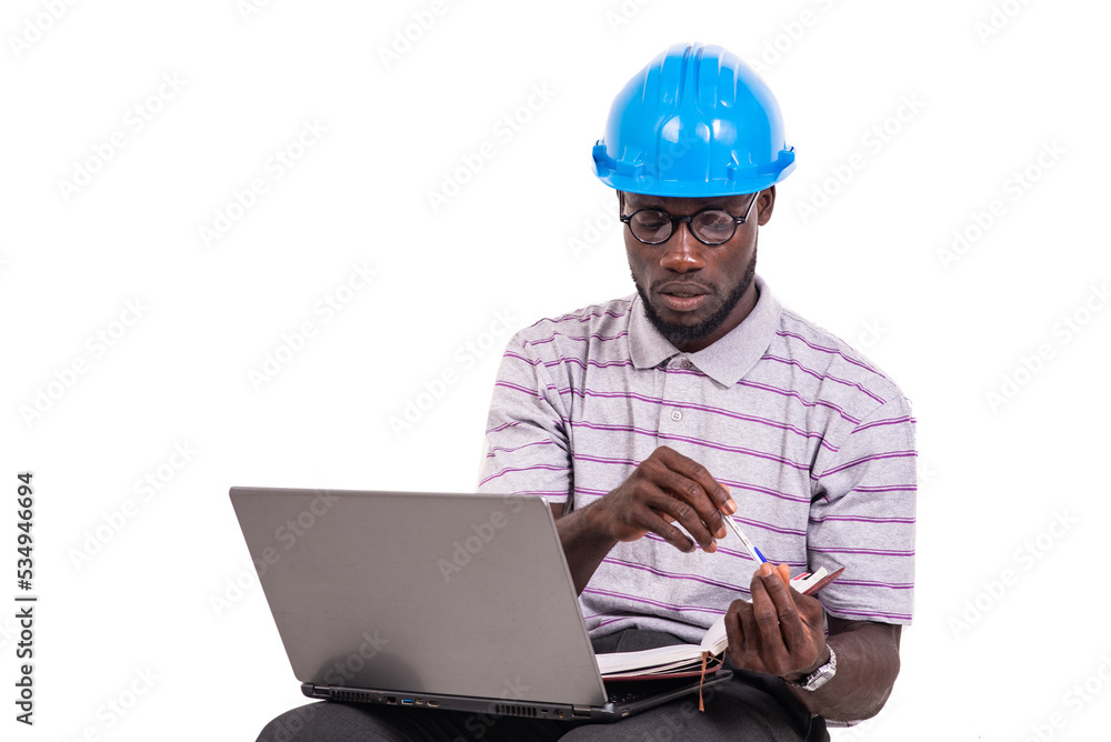 young man engineer working with laptop and notebook. young man engineer working with laptop and notebook.