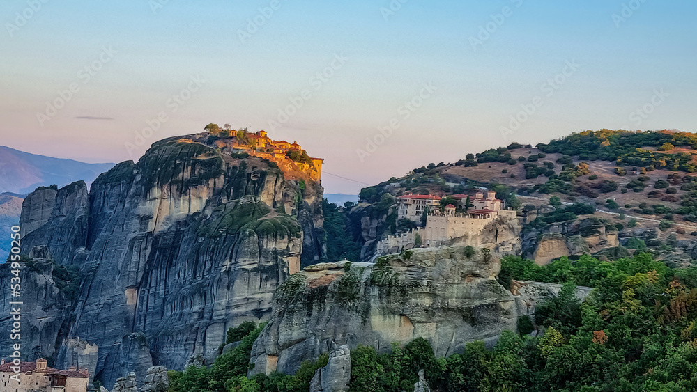 Scenic sunrise view of Holy Monastery of Great Meteoron and Holy Monastery of Varlaam near Kalambaka, Meteora, Thessaly, Greece, Europe. Dramatic landscape. Orthodox landmark build on rock formations