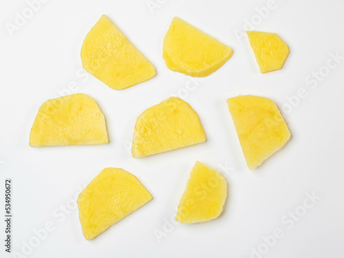 Potatoes slice pieces on white background top view.
