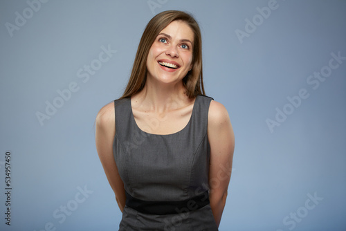 Smiling business woman in office dress looking up.
