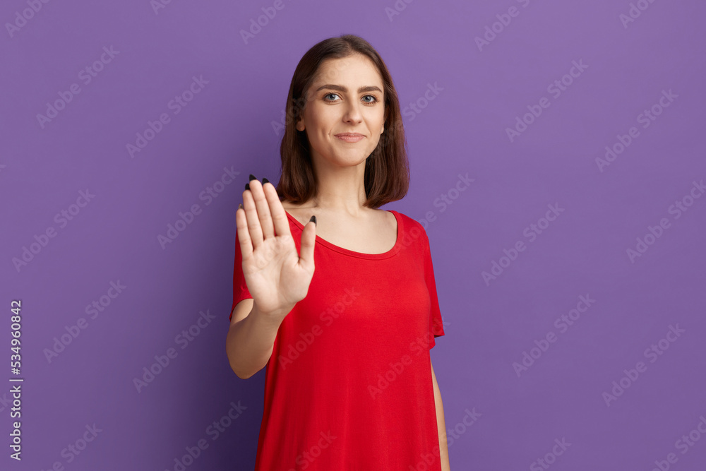 Dont worry I will do it myself. Happy young pretty brunette girl show stop gesture and smiling. Looking at the camera with confidence. Wearing a red t-shirt and posing over purple background. Dont worry I will do it myself. Happy young pretty brunette girl show stop gesture and smiling. Looking at the camera with confidence. Wearing a red t-shirt and posing over purple background.