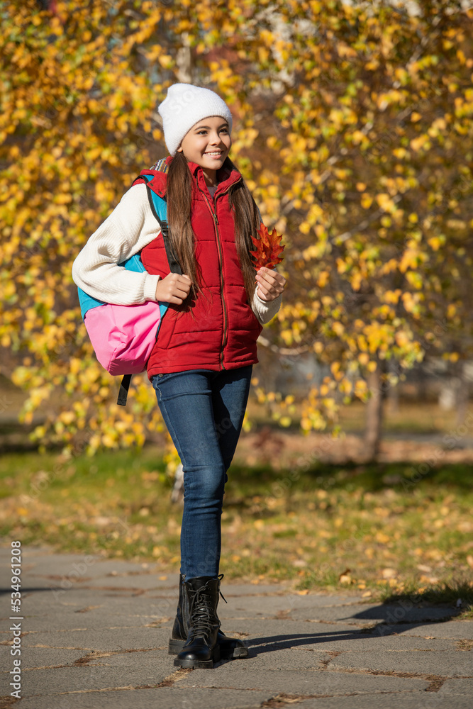 smiling teen child at school time outdoor in autumn season. full length smiling teen child at school time outdoor in autumn season. full length
