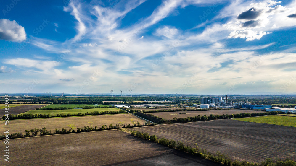 Rural Landscape With Agricultural Fields, Production Factory And Wind Turbines In Austria Rural Landscape With Agricultural Fields, Production Factory And Wind Turbines In Austria