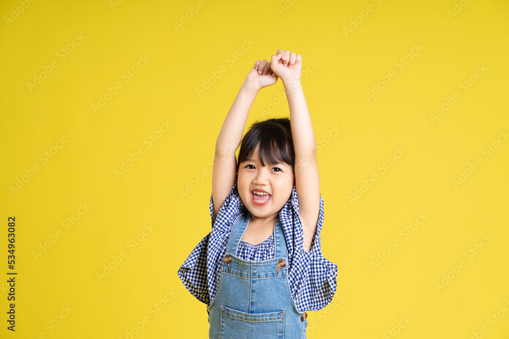 portrait of a beautiful asian girl, isolated on yellow background portrait of a beautiful asian girl, isolated on yellow background