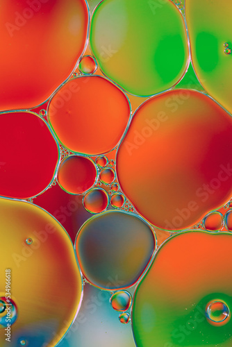 Oil drops in water on a coloured background