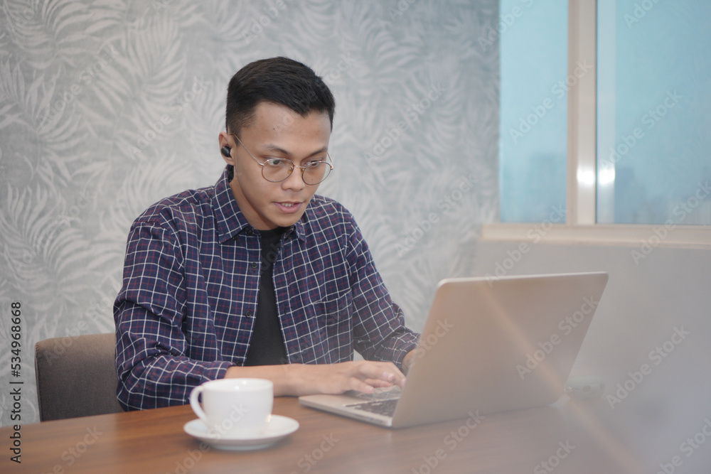 Serious office employee sitting at desk with laptop, preparing report, making online presentation looking focused at work. The concept of using technology Serious office employee sitting at desk with laptop, preparing report, making online presentation looking focused at work. The concept of using technology