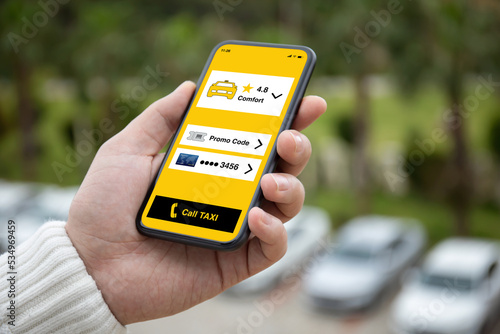 man hand holding phone with app call taxi on screen