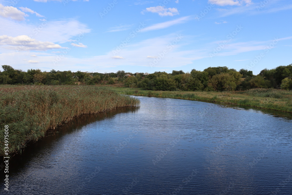 Fototapeta premium flat river flowing into the distance