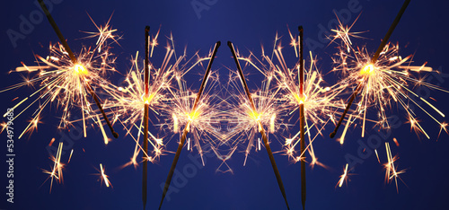 Festive Christmas sparklers on blue background