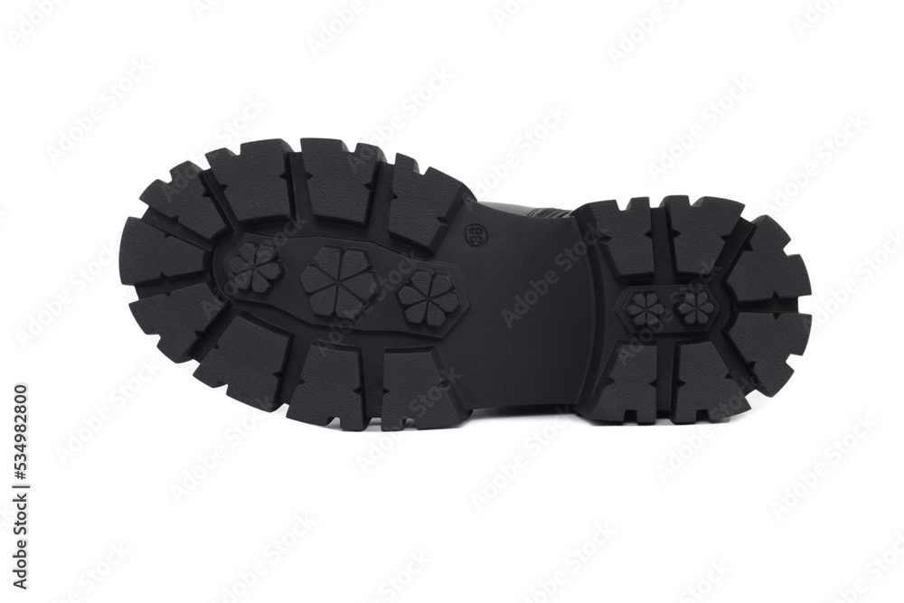 Black sole shoe , isolated on a white background. Fragment of boots with large protektor. Tread pattern on sole. Making and sale of casual shoes. Sale of shoes anti-slip protector. Black sole shoe , isolated on a white background. Fragment of boots with large protektor. Tread pattern on sole. Making and sale of casual shoes. Sale of shoes anti-slip protector.