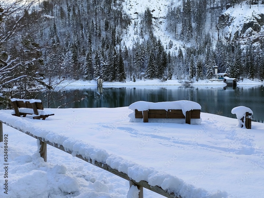 landscape with snow and a bench at Lake Predil on Julian Alps in winter
