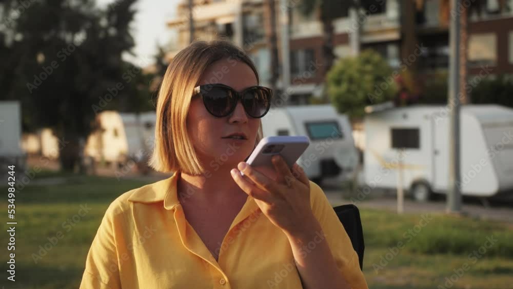 Happy woman using phone, smartphone owner motor home, using phone and relax, making selfie with application, camping van driver smiling, tourist rent bus trailer for camping. Happy woman using phone, smartphone owner motor home, using phone and relax, making selfie with application, camping van driver smiling, tourist rent bus trailer for camping.