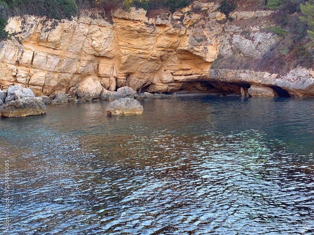 Glittering sea water and coastal rocks at summer evening. Glittering sea water and coastal rocks at summer evening.
