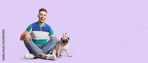 Handsome man and cute pug d...