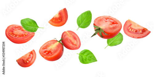 Fresh flying tomatoes and basil isolated on white
