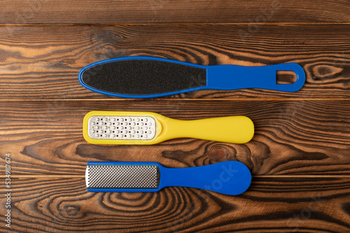 Pedicure tools.Pumice stone and foot file on brown texture background. Close-up. FLAT LAY. Space for text, space for copy. photo