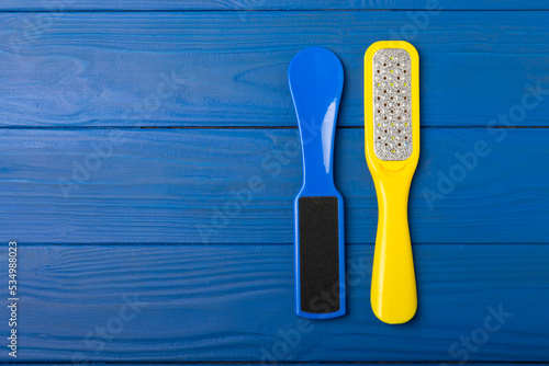 Pedicure tools. Pumice stone and foot file on blue texture background. Close-up. FLAT LAY. Space for text, space for copy. photo