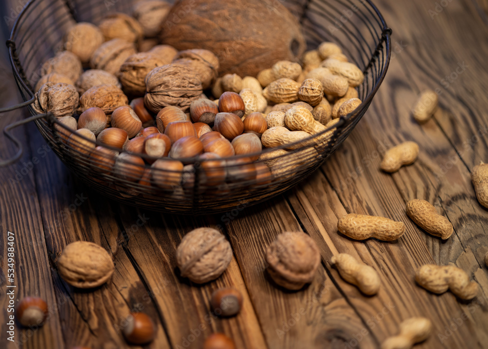 still life with hazelnut peanuts walnut and coconut on wooden board still life with hazelnut peanuts walnut and coconut on wooden board
