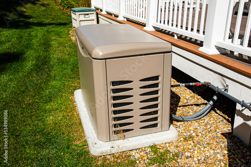Residential standby generator on concrete pad photo
