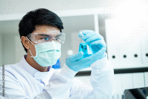 Close-up male scientist, laboratory specialist working with test tubes scientist. Chemist. Science technology concept. Chemistry and medical science research study concepts. Medical Research
