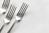Silver forks on white background, closeup