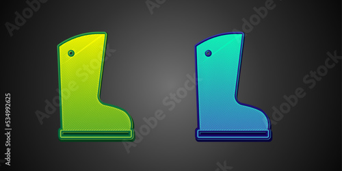 Green and blue Waterproof rubber boot icon isolated on black background. Gumboots for rainy weather, fishing, gardening. Vector