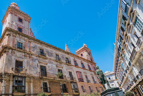 Perspective of the house of four towers and statue, architecture in the San Carlos neighborhood, Cádiz SPAIN photo
