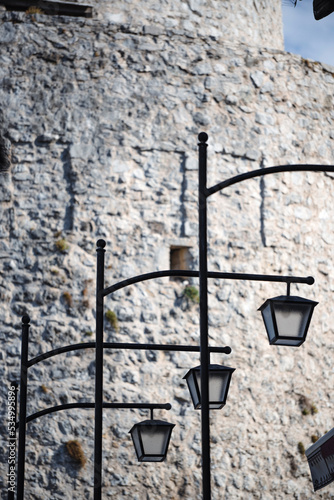 Three vintage street lamps on poles