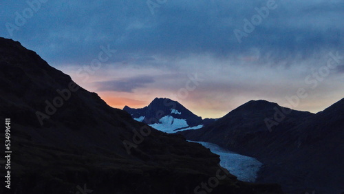Sunset over a glacier in the mountains near Fortuna Bay, South Georgia Island