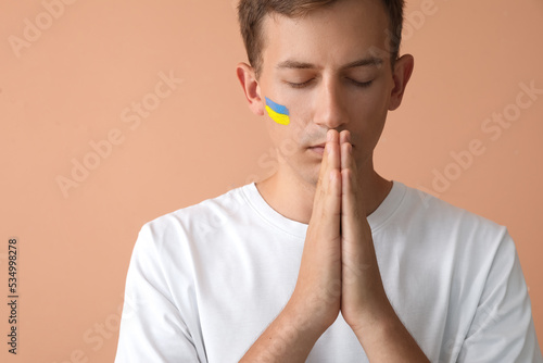 Young man with drawn flag o...