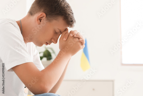 Handsome young man praying ...