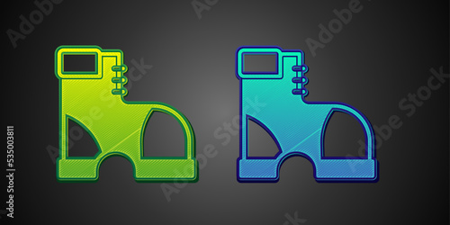 Green and blue Hunter boots icon isolated on black background. Vector