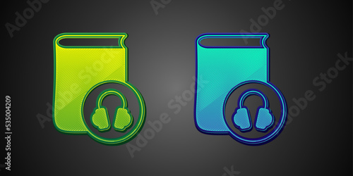 Green and blue Audio book icon isolated on black background. Book with headphones. Audio guide sign. Online learning concept. Vector