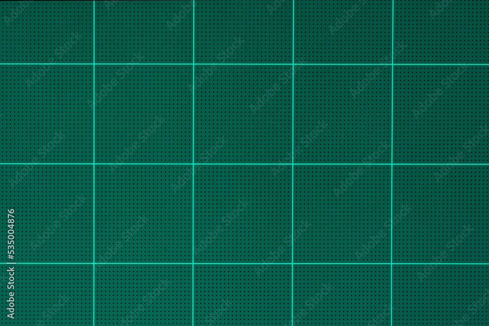 rubber green cutting mat sheet with grid guide line scale square shape background.for paper tools,school or graphic craft studio equipment backdrop design.