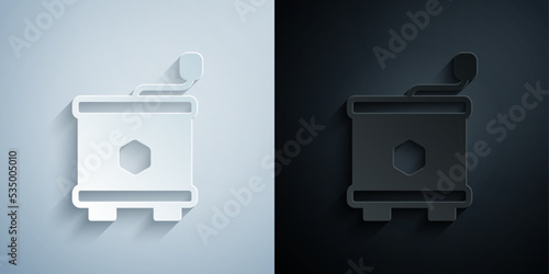 Paper cut Honey extractor icon isolated on grey and black background. Mechanical device for honey extraction from honeycombs. Paper art style. Vector