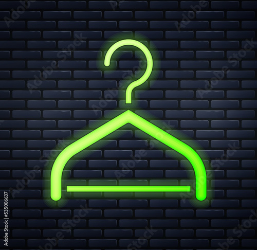 Glowing neon Hanger wardrobe icon isolated on brick wall background. Cloakroom icon. Clothes service symbol. Laundry hanger sign. Vector
