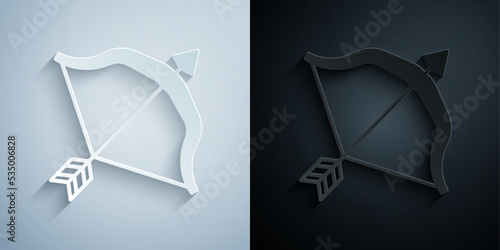 Paper cut Medieval bow and arrow icon isolated on grey and black background. Medieval weapon. Paper art style. Vector