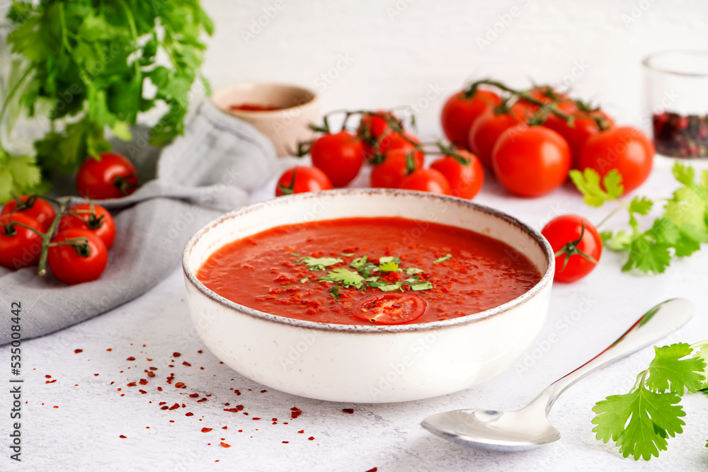Bowl of tasty tomato soup on light background Bowl of tasty tomato soup on light background