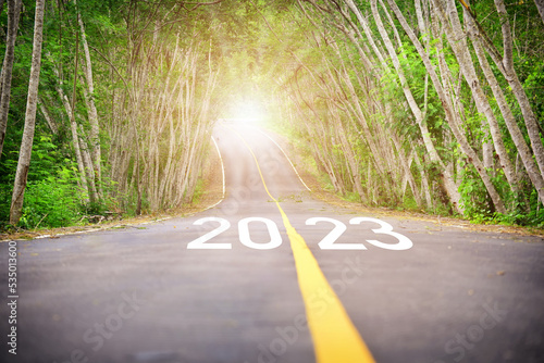 Road to new year 2023 with sunbeam. Business beginning challenge concept and growth mindset idea photo