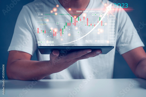 Businessman analysingforex trading graph financial data. Business finance background.Business finance technology and investment concept.2023 business finance technology and investment concept.