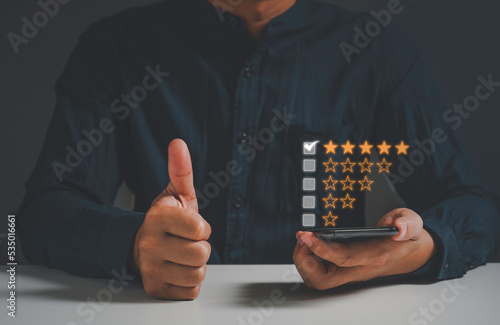 satisfaction concept,man hand thumb up give five stars. with copy space. giving a five star rating. Service rating
