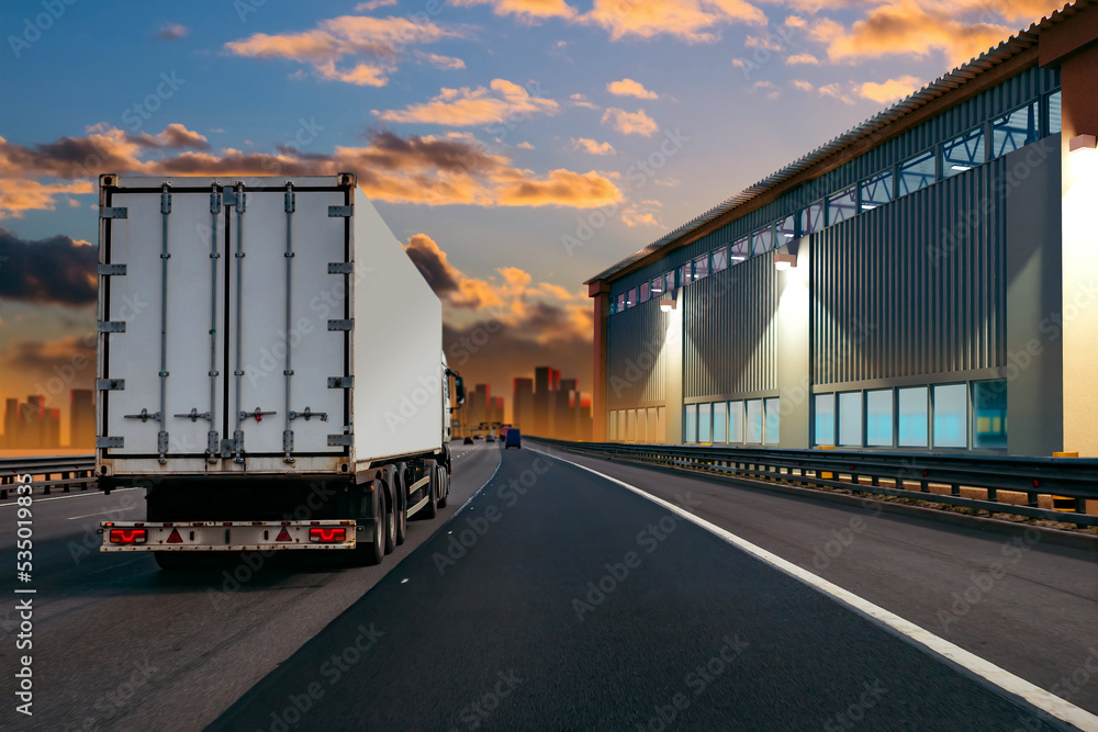 Truck on freeway. Truck is driving on road. Evening track with cargo transport. Freight transportation. Truck drives past industrial building. Freight business. Road logistics concept. 3d rendering.