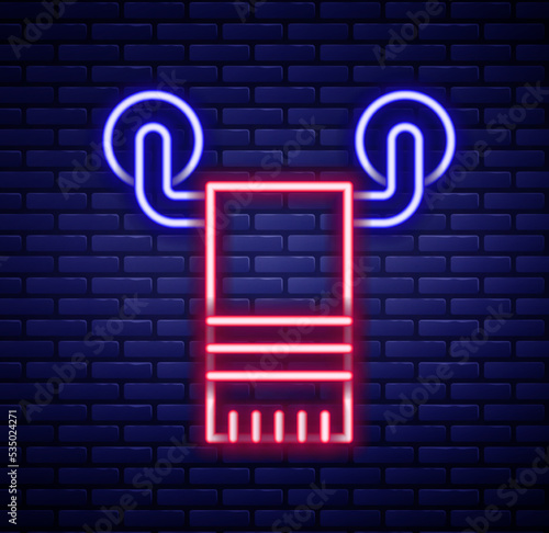 Glowing neon line Towel on hanger icon isolated on brick wall background. Bathroom towel icon. Colorful outline concept. Vector