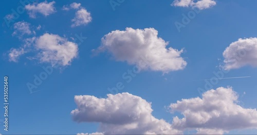 blue sky with clouds and airplane condensation trail timelapse