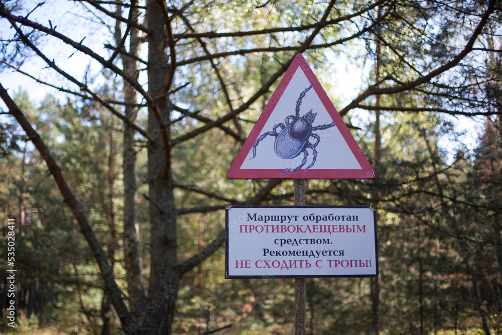 A warning sign about ticks on a walking route in a national park