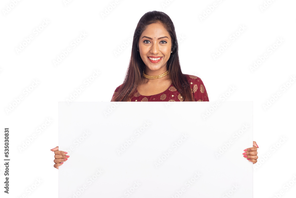 Cheerful Indian young woman holding white board on white background. Cheerful Indian young woman holding white board on white background.