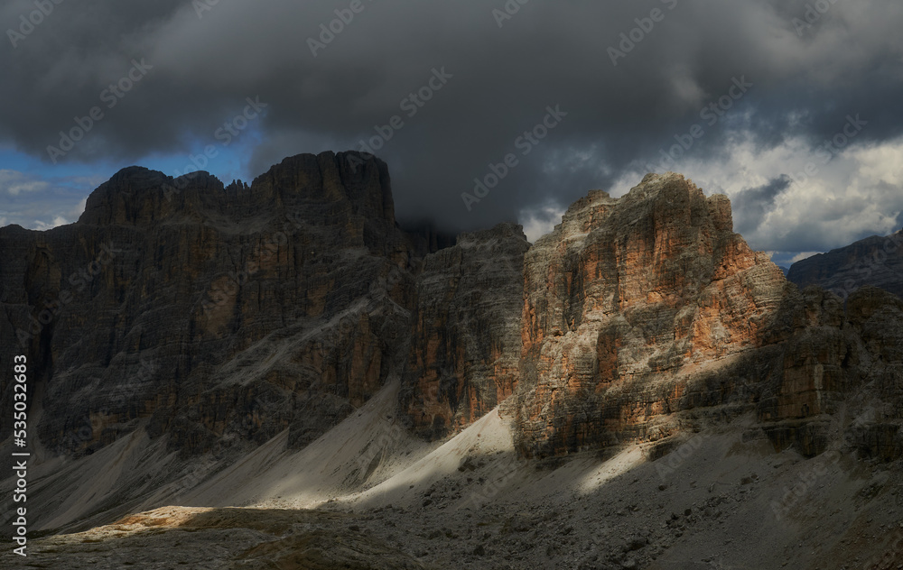 Obraz premium Light breaking through the dark sky in the mountains, atmospheric view, Dolomites, Italian Alps, Italy, Europe