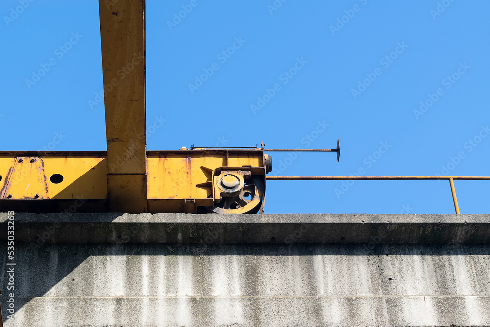 Fototapeta premium Big yellow lifting crane in the factory