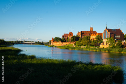 Marienburg Castle the largest medieval brick castle in the world in the city of Malbork at sunset