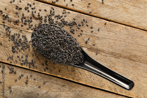 Black sesame seeds in spoon...